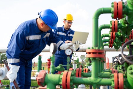 men work on pipes