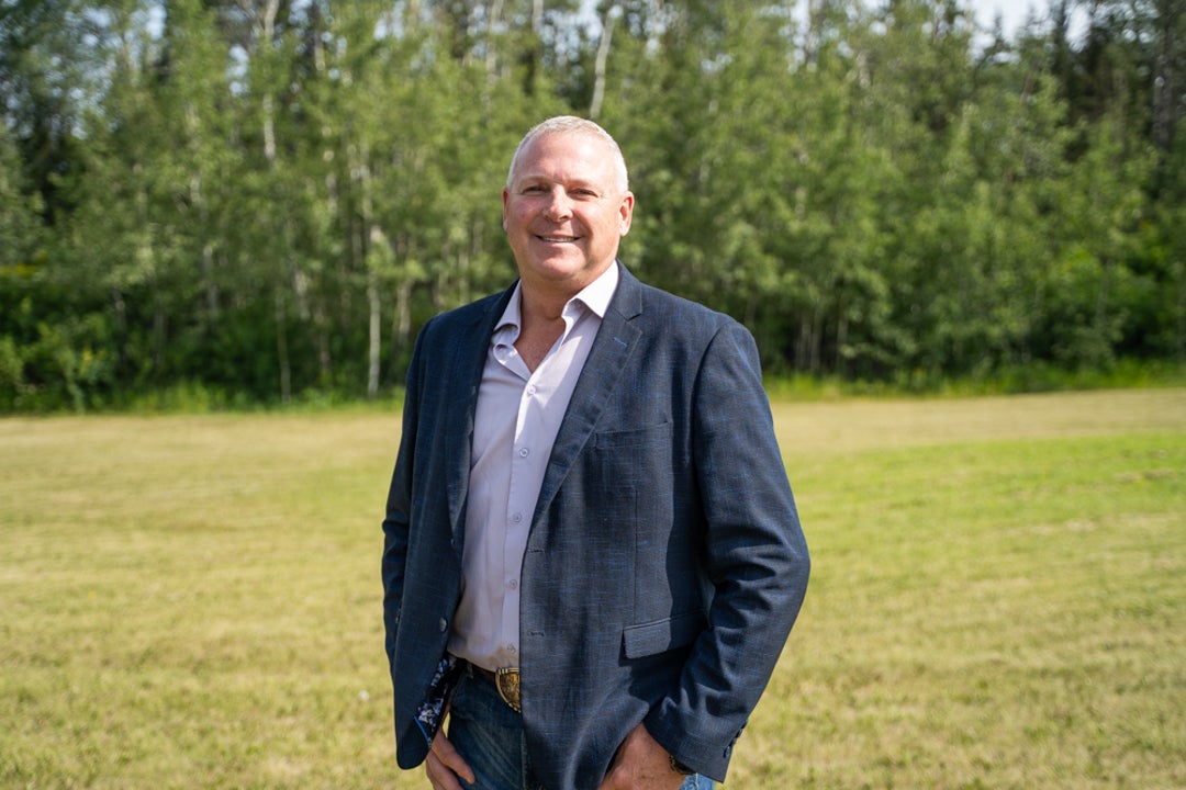 AN image of the new Director of CAEES, David Jeffers, with green grass and trees in the background.