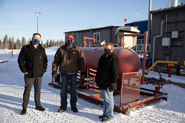 Rodney Cork, Associate Dean of Trades and Apprenticeships; and Elenore Vokes, Oil and Gas Field Operator instructor, stand with Art Jarvis (middle) and the portable gas separator he donated to the NLC simulated wellsite training facility on Jan. 19.