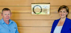 Regional facilities manager Murray Armstrong
and NLC President Laurie Rancourt with the
LEED Platinum plaque on the wall of Energy
House.