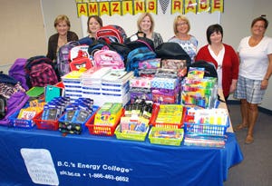 Allyson Hayes (right) of SPCRS accepted a
table full of school supplies collected by staff
at Northern Lights College. Presenting the
supplies on behalf of NLC were President
Laurie Rancourt, and some of the members
of the Networks organizing team Holly
Larden, Anndra Graff, Susan Soutar,
and Jessie Drew.