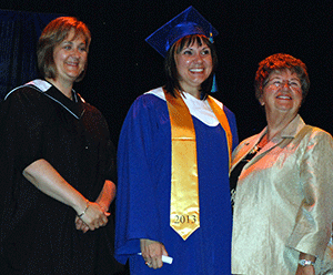 Shelly Owchar, Valedictorian for the 2013 graduating class, received her credential
from NLC President Laurie Rancourt and
NLC Board of Governors member Sharon Miller.