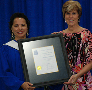 Paulette Flamond receives an Honorary
Associate of Arts degree from NLC Board
of Governors chair Karen Simpson.