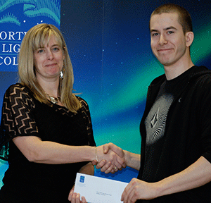 Billie-Jo Crandall presenting the 2013 Duane Sunderman Award to David Hill at the college awards ceremony in Dawson Creek on April 8.