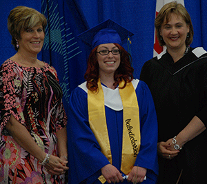 Dana Hall, the 2013 Valedictorian,
received her Applied Business Technology credential from Board Chair Karen Simpson
and President Laurie Rancourt.